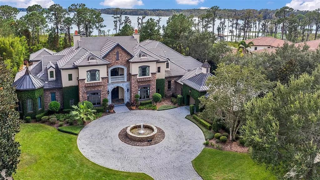 Situated within Windermere's exclusive community, this 10,485-square-foot estate at 6507 Rosella Ct embodies luxury living at its peak. Built by Stonebridge Custom Homes in 2007, the 7-bedroom, 8-bathroom property features an impressive array of amenities including a grand atrium with stunning lake views, a theater, two swimming pools, a spa, and an outdoor kitchen.