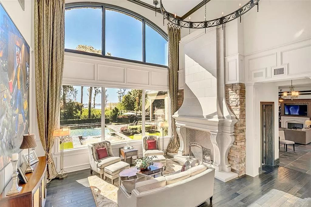 Situated within Windermere's exclusive community, this 10,485-square-foot estate at 6507 Rosella Ct embodies luxury living at its peak. Built by Stonebridge Custom Homes in 2007, the 7-bedroom, 8-bathroom property features an impressive array of amenities including a grand atrium with stunning lake views, a theater, two swimming pools, a spa, and an outdoor kitchen.