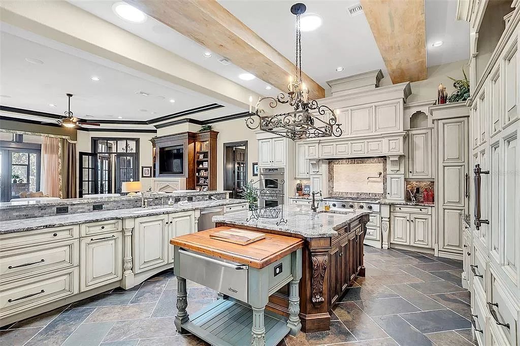 Situated within Windermere's exclusive community, this 10,485-square-foot estate at 6507 Rosella Ct embodies luxury living at its peak. Built by Stonebridge Custom Homes in 2007, the 7-bedroom, 8-bathroom property features an impressive array of amenities including a grand atrium with stunning lake views, a theater, two swimming pools, a spa, and an outdoor kitchen.