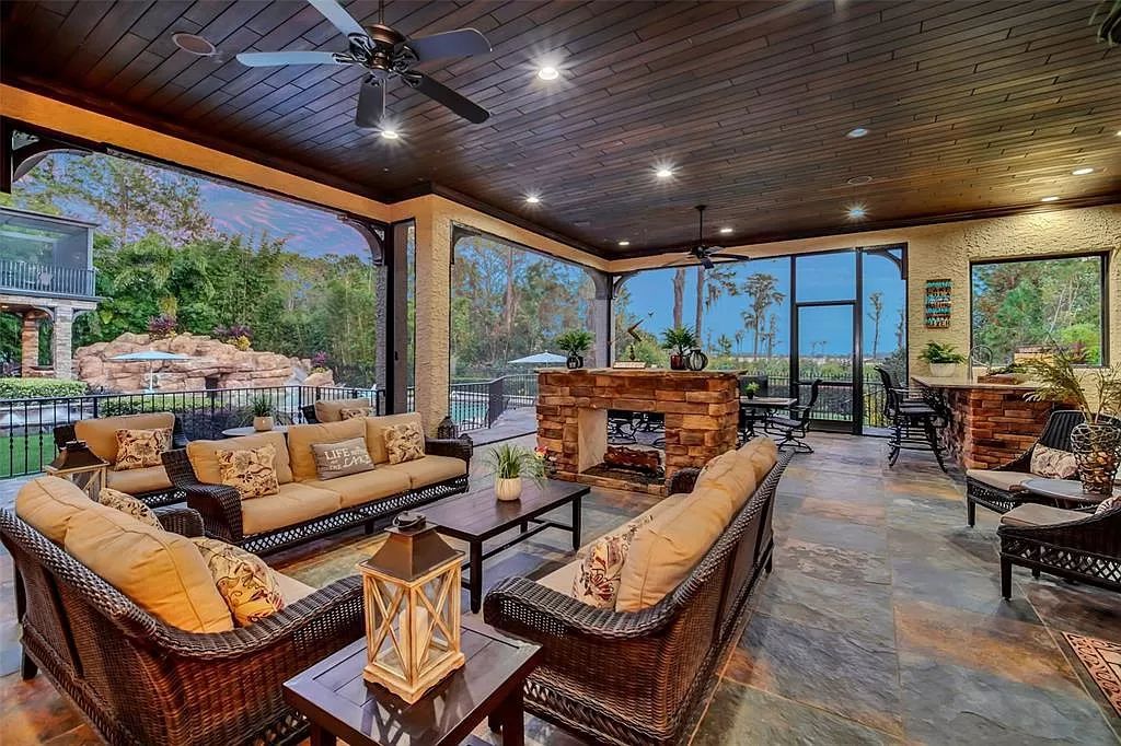 Situated within Windermere's exclusive community, this 10,485-square-foot estate at 6507 Rosella Ct embodies luxury living at its peak. Built by Stonebridge Custom Homes in 2007, the 7-bedroom, 8-bathroom property features an impressive array of amenities including a grand atrium with stunning lake views, a theater, two swimming pools, a spa, and an outdoor kitchen.