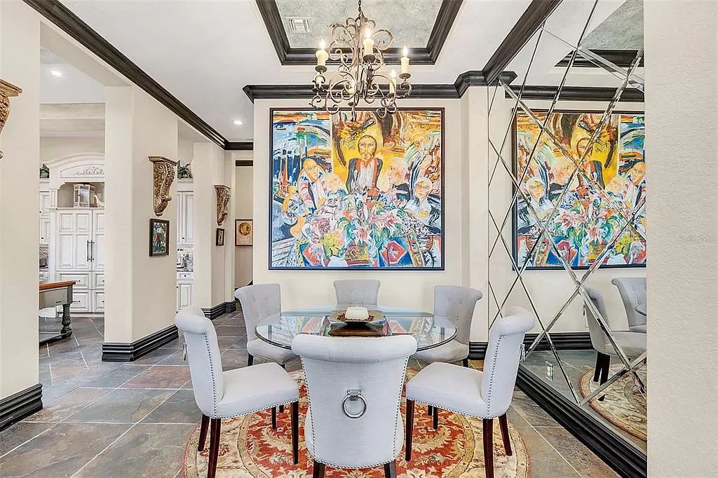 Situated within Windermere's exclusive community, this 10,485-square-foot estate at 6507 Rosella Ct embodies luxury living at its peak. Built by Stonebridge Custom Homes in 2007, the 7-bedroom, 8-bathroom property features an impressive array of amenities including a grand atrium with stunning lake views, a theater, two swimming pools, a spa, and an outdoor kitchen.