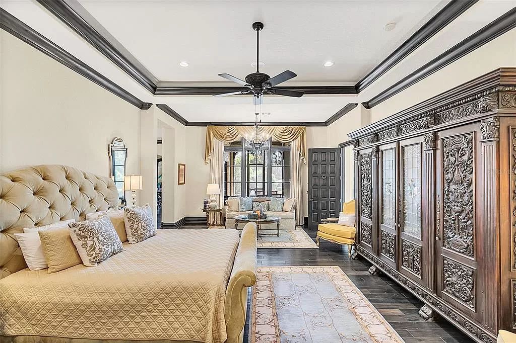 Situated within Windermere's exclusive community, this 10,485-square-foot estate at 6507 Rosella Ct embodies luxury living at its peak. Built by Stonebridge Custom Homes in 2007, the 7-bedroom, 8-bathroom property features an impressive array of amenities including a grand atrium with stunning lake views, a theater, two swimming pools, a spa, and an outdoor kitchen.