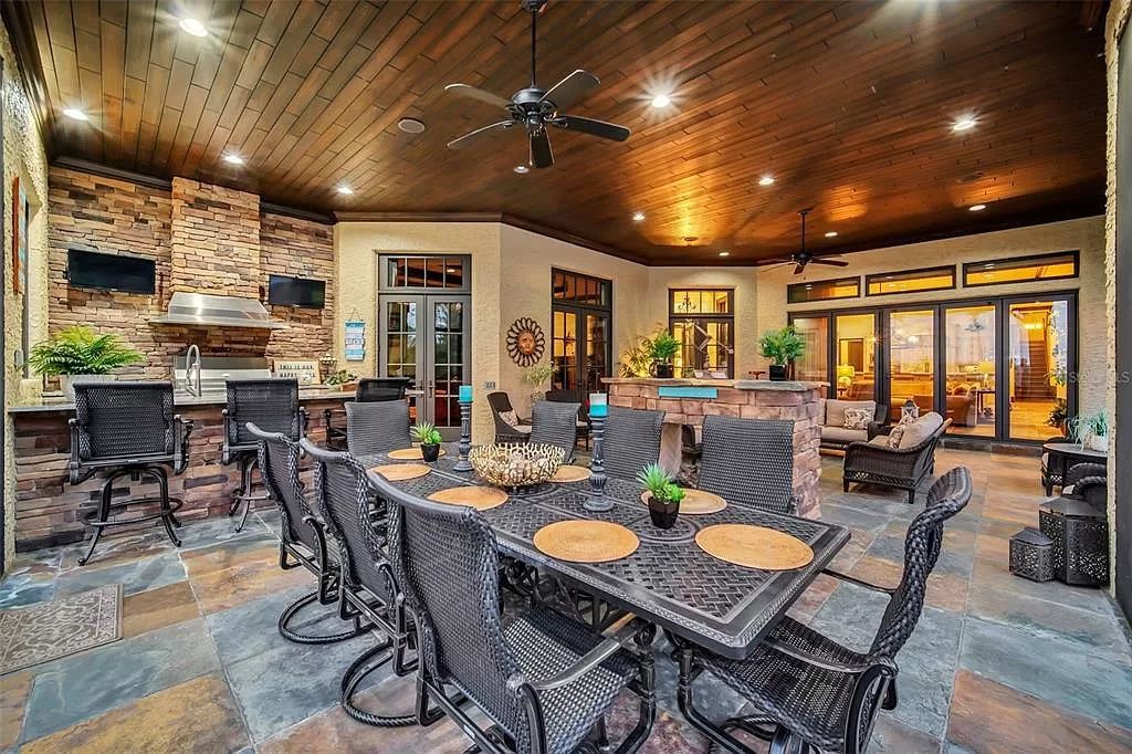 Situated within Windermere's exclusive community, this 10,485-square-foot estate at 6507 Rosella Ct embodies luxury living at its peak. Built by Stonebridge Custom Homes in 2007, the 7-bedroom, 8-bathroom property features an impressive array of amenities including a grand atrium with stunning lake views, a theater, two swimming pools, a spa, and an outdoor kitchen.