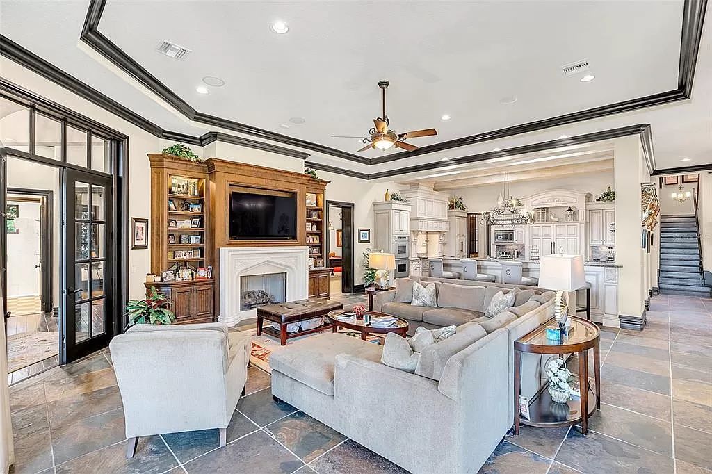 Situated within Windermere's exclusive community, this 10,485-square-foot estate at 6507 Rosella Ct embodies luxury living at its peak. Built by Stonebridge Custom Homes in 2007, the 7-bedroom, 8-bathroom property features an impressive array of amenities including a grand atrium with stunning lake views, a theater, two swimming pools, a spa, and an outdoor kitchen.