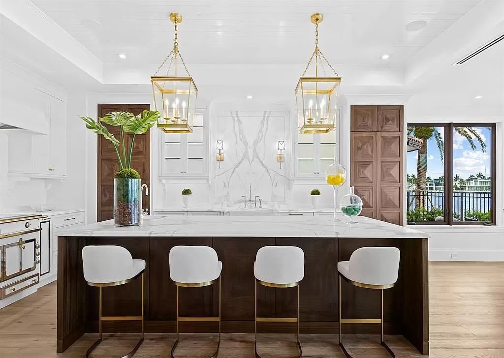 Immerse yourself in the epitome of the "South Florida Lifestyle" at this exquisitely renovated 6-bed, 8-bath West Indies Oasis at 1812 SE 14th St, Fort Lauderdale, FL. This 7,221 sq ft estate boasts a grand Great Room with 20' ceilings and panoramic water views, a media room, and a chef's kitchen with a La’Corneu gas range.