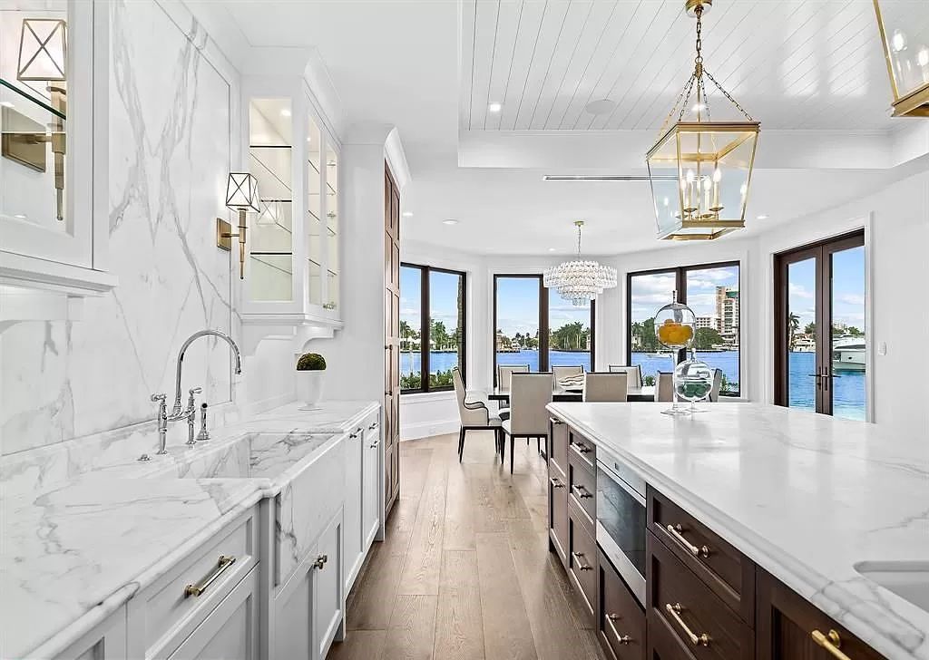 Immerse yourself in the epitome of the "South Florida Lifestyle" at this exquisitely renovated 6-bed, 8-bath West Indies Oasis at 1812 SE 14th St, Fort Lauderdale, FL. This 7,221 sq ft estate boasts a grand Great Room with 20' ceilings and panoramic water views, a media room, and a chef's kitchen with a La’Corneu gas range.