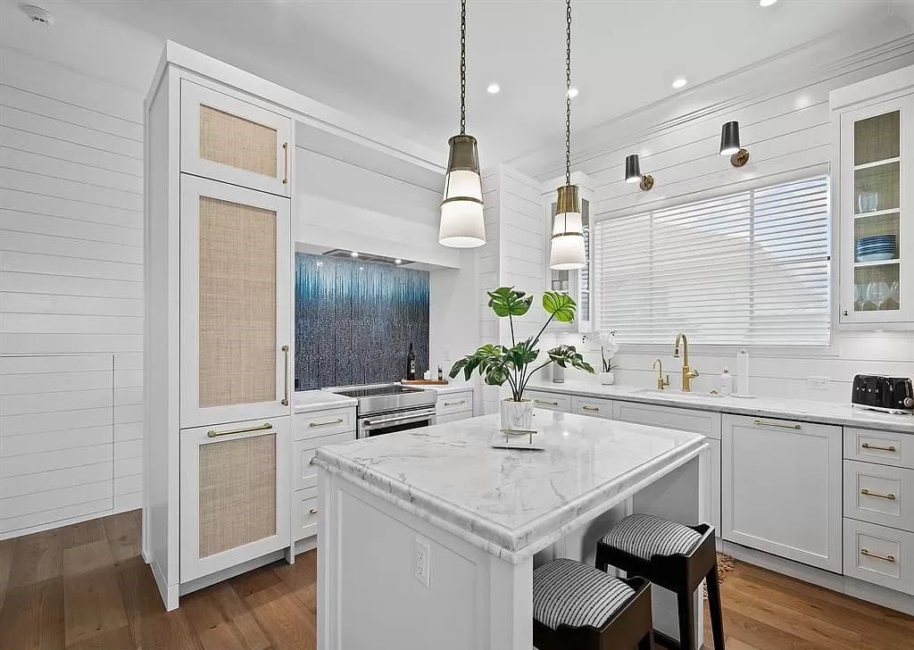 Immerse yourself in the epitome of the "South Florida Lifestyle" at this exquisitely renovated 6-bed, 8-bath West Indies Oasis at 1812 SE 14th St, Fort Lauderdale, FL. This 7,221 sq ft estate boasts a grand Great Room with 20' ceilings and panoramic water views, a media room, and a chef's kitchen with a La’Corneu gas range.