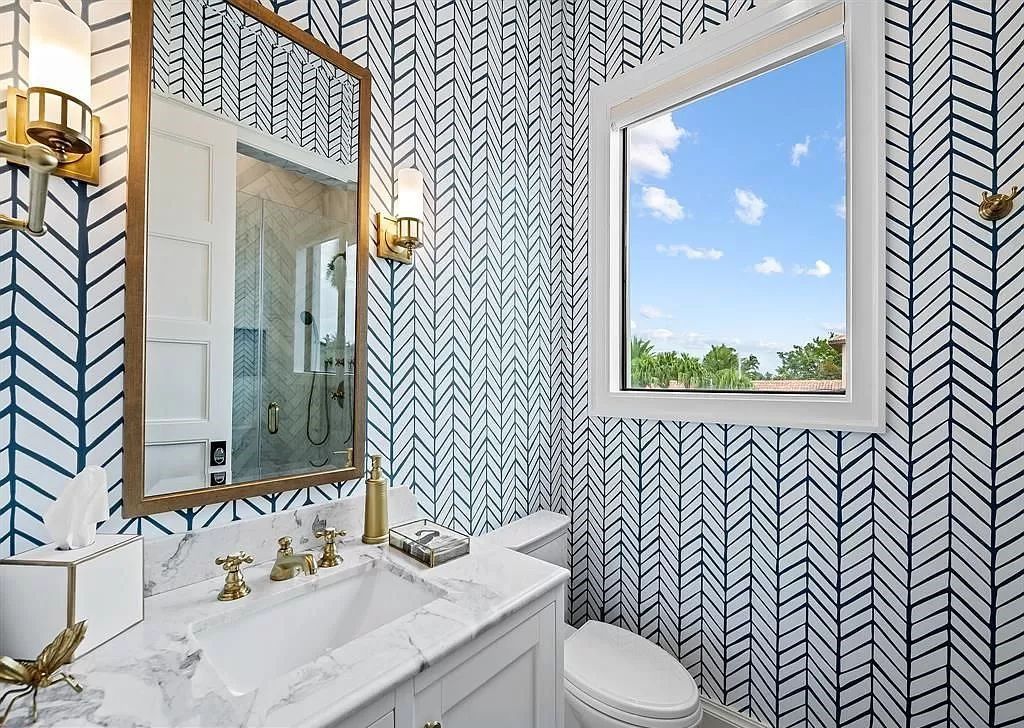 Immerse yourself in the epitome of the "South Florida Lifestyle" at this exquisitely renovated 6-bed, 8-bath West Indies Oasis at 1812 SE 14th St, Fort Lauderdale, FL. This 7,221 sq ft estate boasts a grand Great Room with 20' ceilings and panoramic water views, a media room, and a chef's kitchen with a La’Corneu gas range.