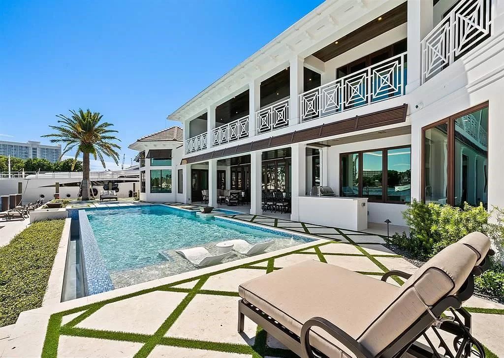 Immerse yourself in the epitome of the "South Florida Lifestyle" at this exquisitely renovated 6-bed, 8-bath West Indies Oasis at 1812 SE 14th St, Fort Lauderdale, FL. This 7,221 sq ft estate boasts a grand Great Room with 20' ceilings and panoramic water views, a media room, and a chef's kitchen with a La’Corneu gas range.