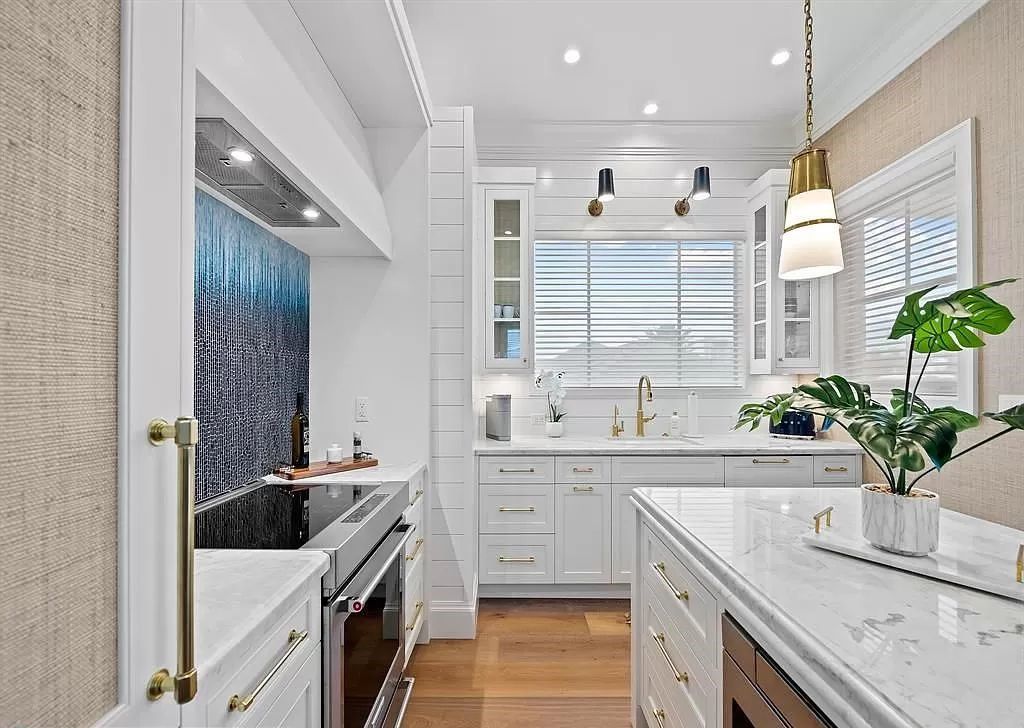Immerse yourself in the epitome of the "South Florida Lifestyle" at this exquisitely renovated 6-bed, 8-bath West Indies Oasis at 1812 SE 14th St, Fort Lauderdale, FL. This 7,221 sq ft estate boasts a grand Great Room with 20' ceilings and panoramic water views, a media room, and a chef's kitchen with a La’Corneu gas range.