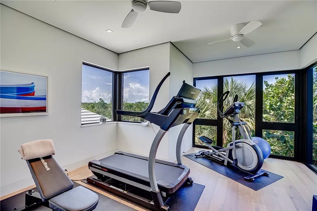 This modern oceanfront estate, located at 6600 N Highway A1a, Hutchinson Island, Florida, spans 1.5 acres and offers unparalleled privacy. With 149 glass windows and doors, it seamlessly blends stone, wood, and glass, creating a masterpiece of luxury and tranquility.