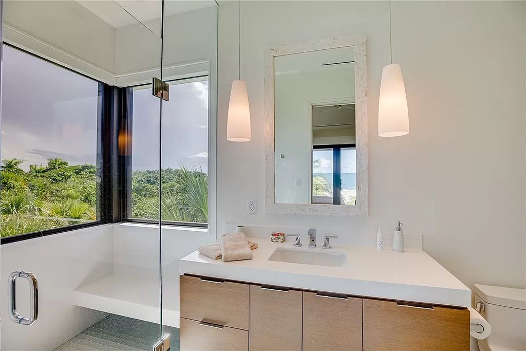 This modern oceanfront estate, located at 6600 N Highway A1a, Hutchinson Island, Florida, spans 1.5 acres and offers unparalleled privacy. With 149 glass windows and doors, it seamlessly blends stone, wood, and glass, creating a masterpiece of luxury and tranquility.