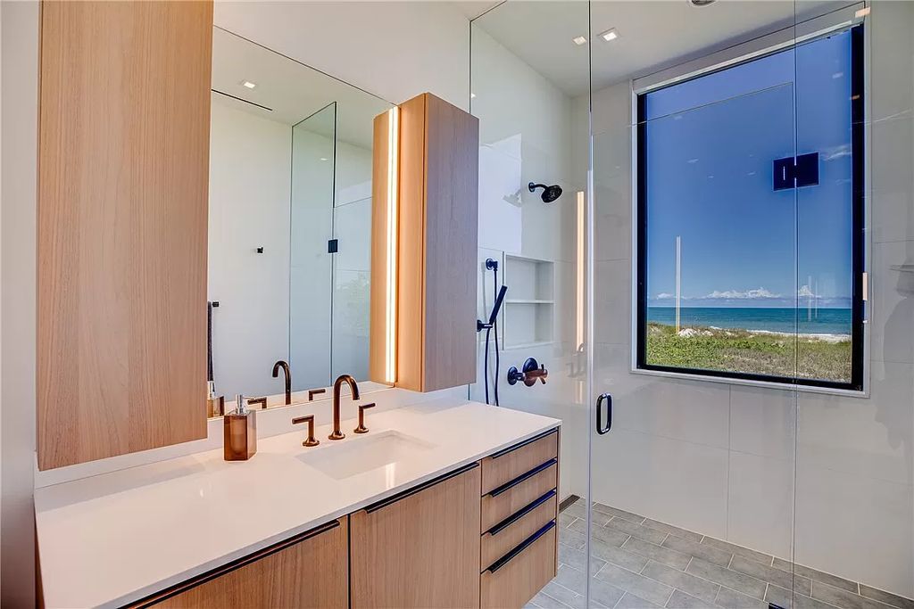 This modern oceanfront estate, located at 6600 N Highway A1a, Hutchinson Island, Florida, spans 1.5 acres and offers unparalleled privacy. With 149 glass windows and doors, it seamlessly blends stone, wood, and glass, creating a masterpiece of luxury and tranquility.