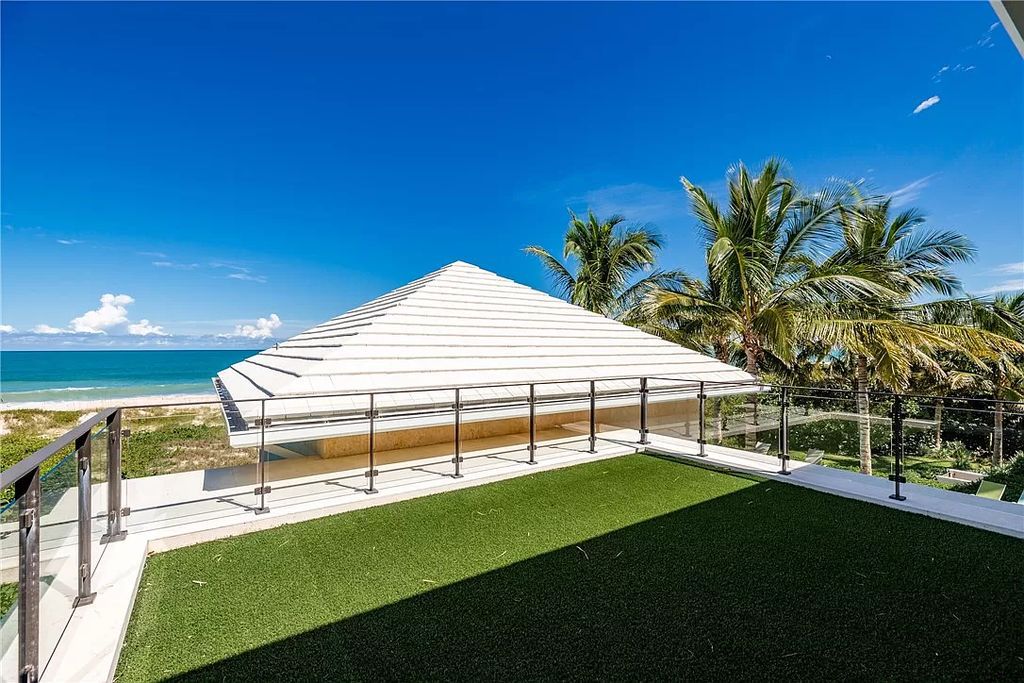 This modern oceanfront estate, located at 6600 N Highway A1a, Hutchinson Island, Florida, spans 1.5 acres and offers unparalleled privacy. With 149 glass windows and doors, it seamlessly blends stone, wood, and glass, creating a masterpiece of luxury and tranquility.