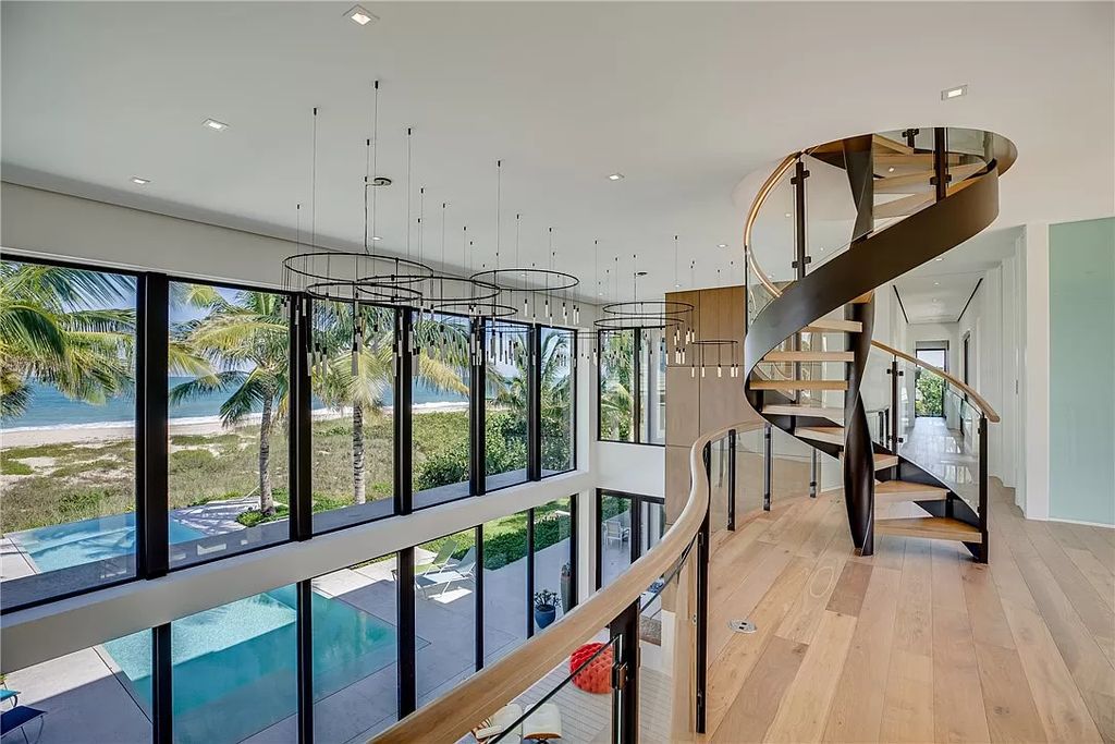 This modern oceanfront estate, located at 6600 N Highway A1a, Hutchinson Island, Florida, spans 1.5 acres and offers unparalleled privacy. With 149 glass windows and doors, it seamlessly blends stone, wood, and glass, creating a masterpiece of luxury and tranquility.