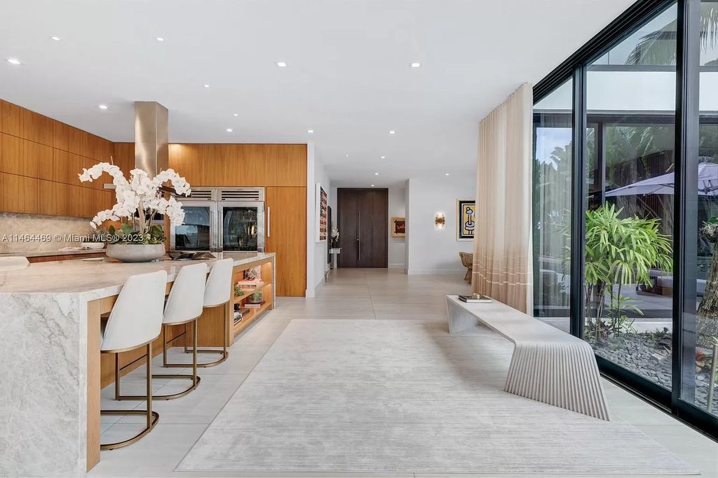 Discover the pinnacle of Miami Beach luxury living at 1142 N Venetian Dr, FL 33139. This 6-bedroom, 6-bath residence spans 6,685 sqft, boasting a seamless blend of contemporary design and comfort. Nestled on the soon-to-be exclusive gated section of the Venetian Islands, this home offers a louvered dining area, media lounge, suede-paneled living salon, and an expansive teak kitchen with Miele & SubZero appliances.