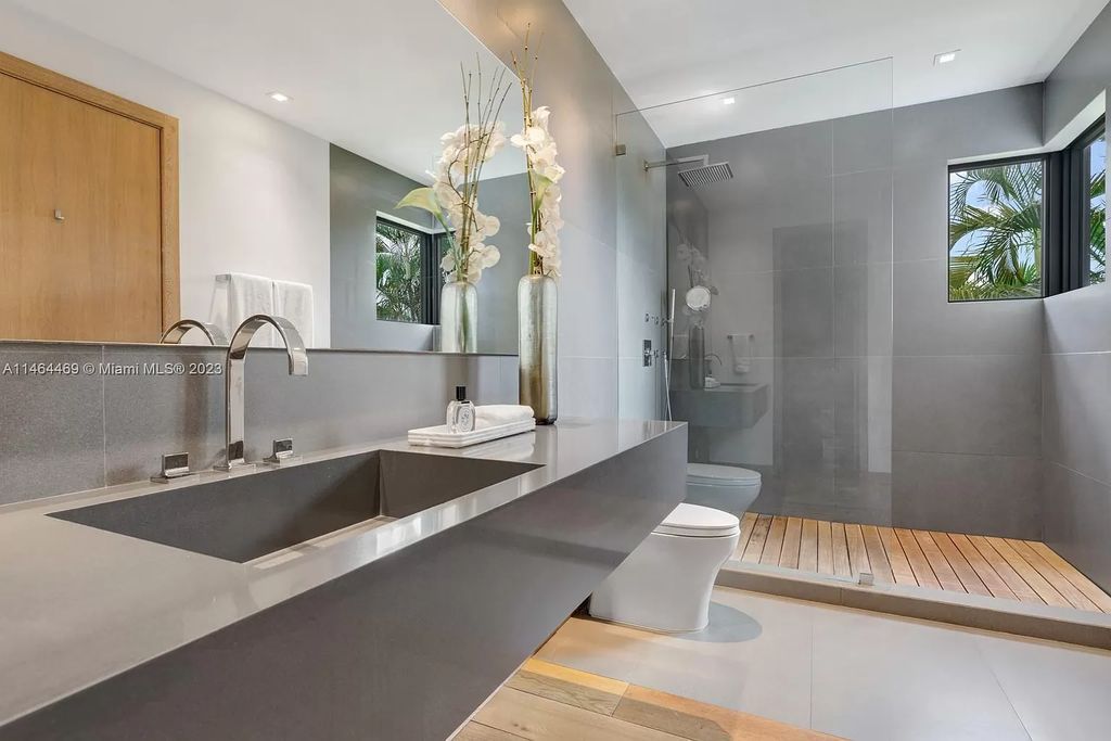 Discover the pinnacle of Miami Beach luxury living at 1142 N Venetian Dr, FL 33139. This 6-bedroom, 6-bath residence spans 6,685 sqft, boasting a seamless blend of contemporary design and comfort. Nestled on the soon-to-be exclusive gated section of the Venetian Islands, this home offers a louvered dining area, media lounge, suede-paneled living salon, and an expansive teak kitchen with Miele & SubZero appliances.