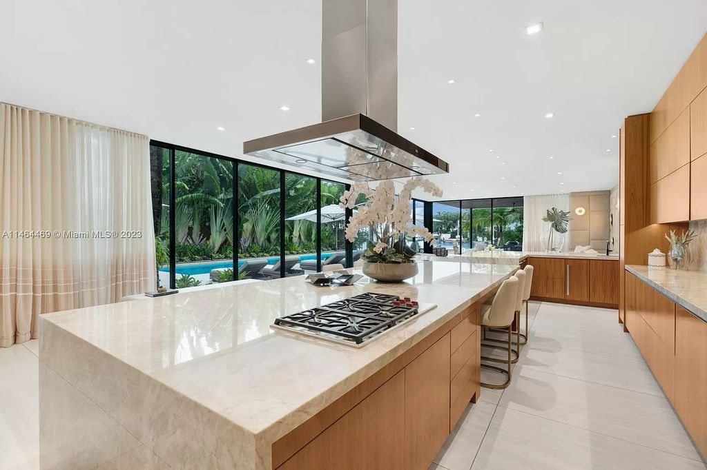 Discover the pinnacle of Miami Beach luxury living at 1142 N Venetian Dr, FL 33139. This 6-bedroom, 6-bath residence spans 6,685 sqft, boasting a seamless blend of contemporary design and comfort. Nestled on the soon-to-be exclusive gated section of the Venetian Islands, this home offers a louvered dining area, media lounge, suede-paneled living salon, and an expansive teak kitchen with Miele & SubZero appliances.