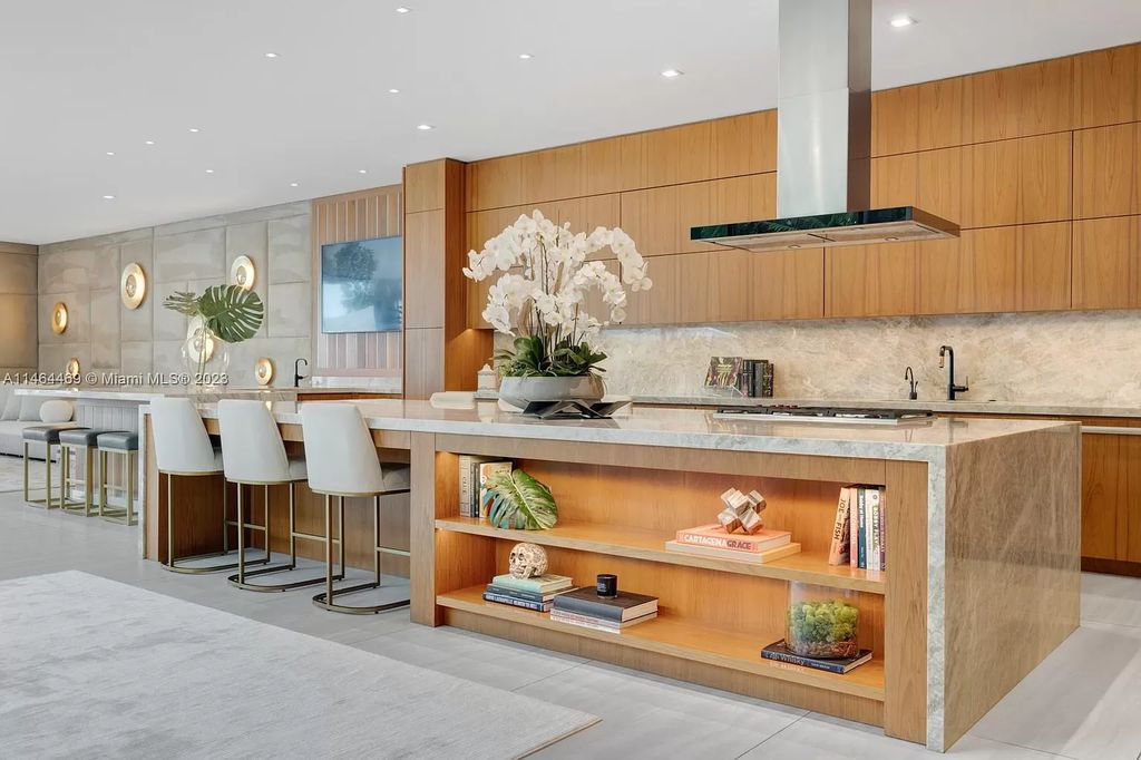 Discover the pinnacle of Miami Beach luxury living at 1142 N Venetian Dr, FL 33139. This 6-bedroom, 6-bath residence spans 6,685 sqft, boasting a seamless blend of contemporary design and comfort. Nestled on the soon-to-be exclusive gated section of the Venetian Islands, this home offers a louvered dining area, media lounge, suede-paneled living salon, and an expansive teak kitchen with Miele & SubZero appliances.