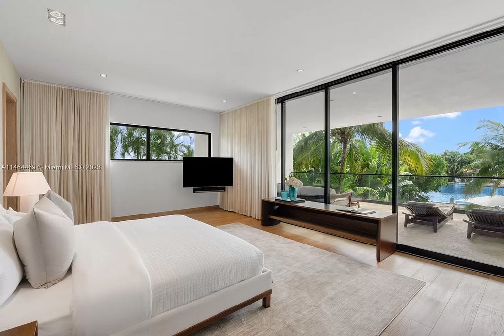 Discover the pinnacle of Miami Beach luxury living at 1142 N Venetian Dr, FL 33139. This 6-bedroom, 6-bath residence spans 6,685 sqft, boasting a seamless blend of contemporary design and comfort. Nestled on the soon-to-be exclusive gated section of the Venetian Islands, this home offers a louvered dining area, media lounge, suede-paneled living salon, and an expansive teak kitchen with Miele & SubZero appliances.