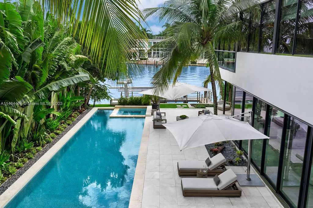 Discover the pinnacle of Miami Beach luxury living at 1142 N Venetian Dr, FL 33139. This 6-bedroom, 6-bath residence spans 6,685 sqft, boasting a seamless blend of contemporary design and comfort. Nestled on the soon-to-be exclusive gated section of the Venetian Islands, this home offers a louvered dining area, media lounge, suede-paneled living salon, and an expansive teak kitchen with Miele & SubZero appliances.