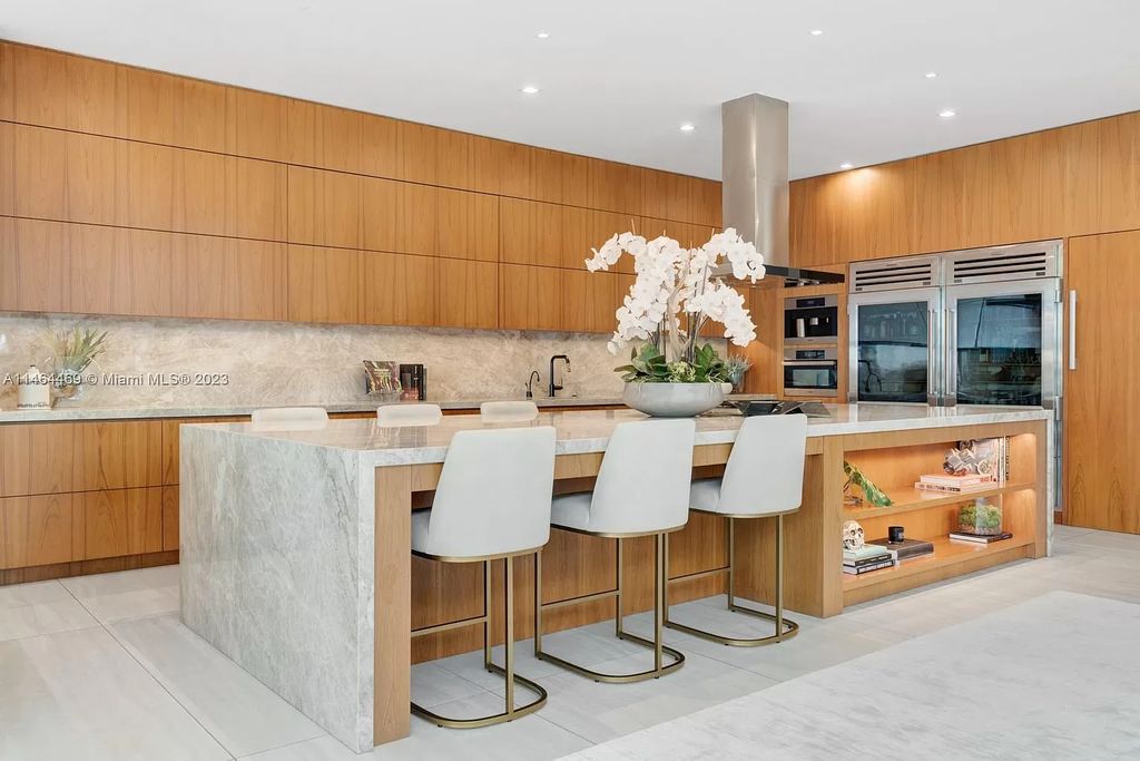 Discover the pinnacle of Miami Beach luxury living at 1142 N Venetian Dr, FL 33139. This 6-bedroom, 6-bath residence spans 6,685 sqft, boasting a seamless blend of contemporary design and comfort. Nestled on the soon-to-be exclusive gated section of the Venetian Islands, this home offers a louvered dining area, media lounge, suede-paneled living salon, and an expansive teak kitchen with Miele & SubZero appliances.