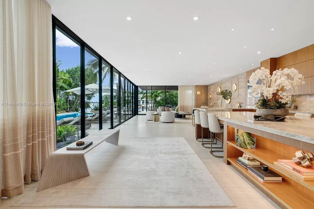 Discover the pinnacle of Miami Beach luxury living at 1142 N Venetian Dr, FL 33139. This 6-bedroom, 6-bath residence spans 6,685 sqft, boasting a seamless blend of contemporary design and comfort. Nestled on the soon-to-be exclusive gated section of the Venetian Islands, this home offers a louvered dining area, media lounge, suede-paneled living salon, and an expansive teak kitchen with Miele & SubZero appliances.