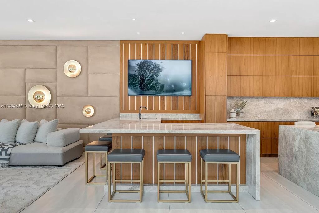 Discover the pinnacle of Miami Beach luxury living at 1142 N Venetian Dr, FL 33139. This 6-bedroom, 6-bath residence spans 6,685 sqft, boasting a seamless blend of contemporary design and comfort. Nestled on the soon-to-be exclusive gated section of the Venetian Islands, this home offers a louvered dining area, media lounge, suede-paneled living salon, and an expansive teak kitchen with Miele & SubZero appliances.