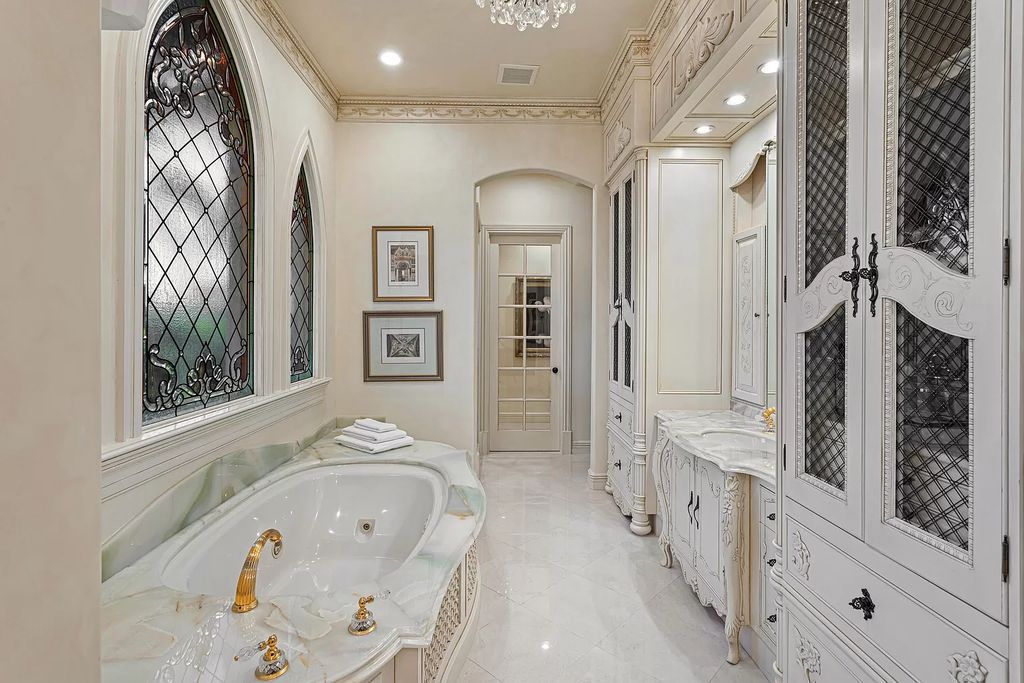 Nestled on a prime 1.06-acre waterfront estate at 5001 Egret Point Circle, Boca Raton, this Italianate marvel in The Sanctuary presents 8 bedrooms, 14 baths, and 14,848 square feet of opulent living space, meticulously crafted in 2005.
