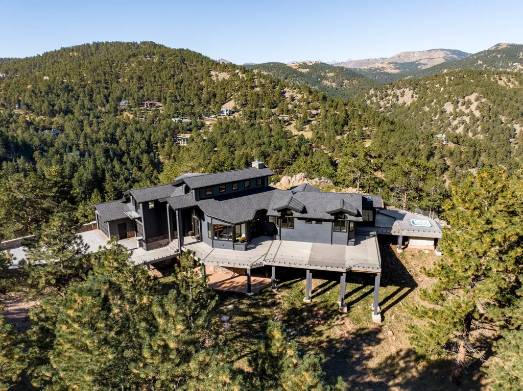 155 Wildwood Lane Home in Boulder, Colorado. Discover tranquility and luxury in this Pine Brook Hills home featuring stunning views of the Continental Divide. With an open floorplan, contemporary finishes, and spacious outdoor decks, this Boulder retreat offers a perfect blend of modern living and natural beauty.