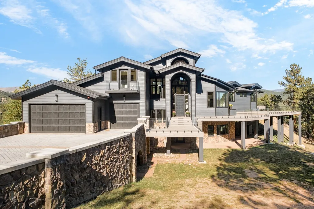 155 Wildwood Lane Home in Boulder, Colorado. Discover tranquility and luxury in this Pine Brook Hills home featuring stunning views of the Continental Divide. With an open floorplan, contemporary finishes, and spacious outdoor decks, this Boulder retreat offers a perfect blend of modern living and natural beauty.
