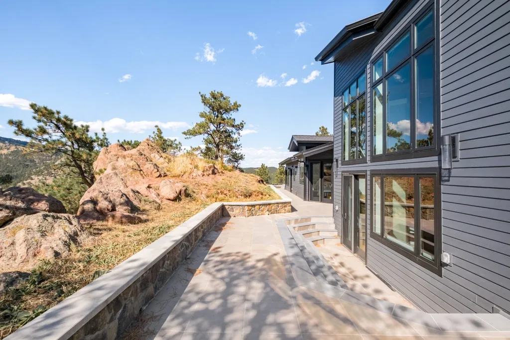 155 Wildwood Lane Home in Boulder, Colorado. Discover tranquility and luxury in this Pine Brook Hills home featuring stunning views of the Continental Divide. With an open floorplan, contemporary finishes, and spacious outdoor decks, this Boulder retreat offers a perfect blend of modern living and natural beauty.