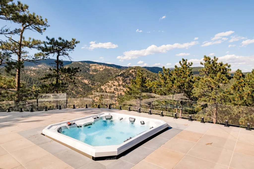 155 Wildwood Lane Home in Boulder, Colorado. Discover tranquility and luxury in this Pine Brook Hills home featuring stunning views of the Continental Divide. With an open floorplan, contemporary finishes, and spacious outdoor decks, this Boulder retreat offers a perfect blend of modern living and natural beauty.