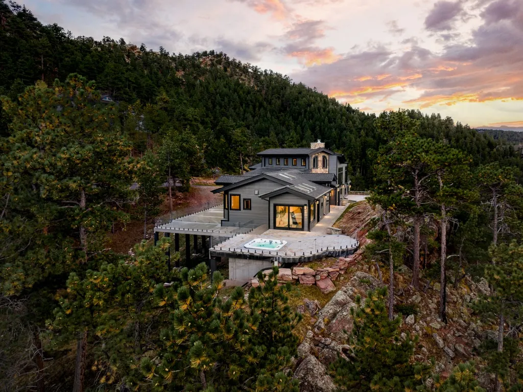 155 Wildwood Lane Home in Boulder, Colorado. Discover tranquility and luxury in this Pine Brook Hills home featuring stunning views of the Continental Divide. With an open floorplan, contemporary finishes, and spacious outdoor decks, this Boulder retreat offers a perfect blend of modern living and natural beauty.