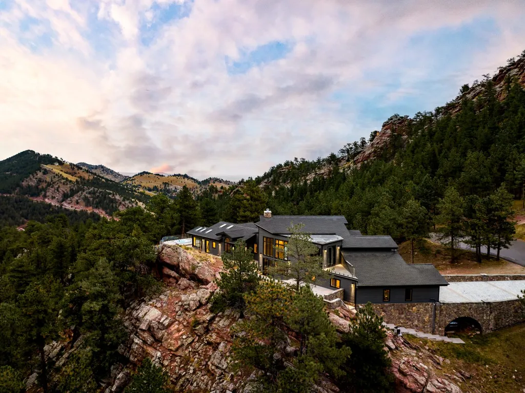 155 Wildwood Lane Home in Boulder, Colorado. Discover tranquility and luxury in this Pine Brook Hills home featuring stunning views of the Continental Divide. With an open floorplan, contemporary finishes, and spacious outdoor decks, this Boulder retreat offers a perfect blend of modern living and natural beauty.