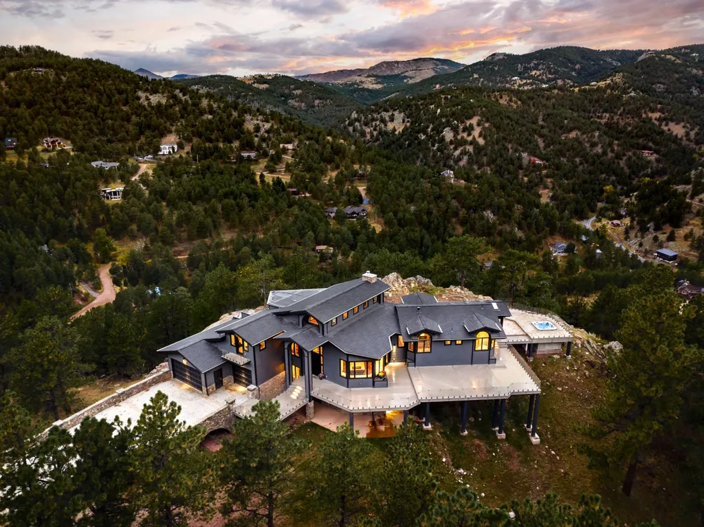 155 Wildwood Lane Home in Boulder, Colorado. Discover tranquility and luxury in this Pine Brook Hills home featuring stunning views of the Continental Divide. With an open floorplan, contemporary finishes, and spacious outdoor decks, this Boulder retreat offers a perfect blend of modern living and natural beauty.