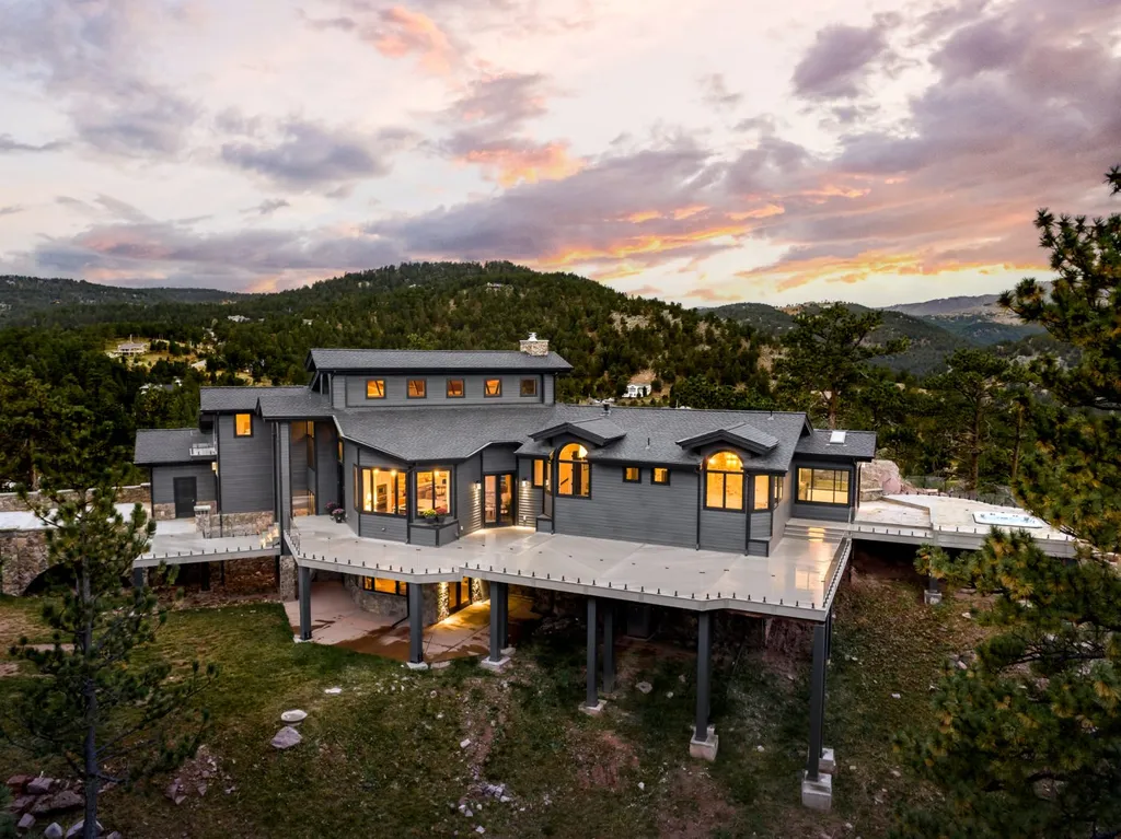 155 Wildwood Lane Home in Boulder, Colorado. Discover tranquility and luxury in this Pine Brook Hills home featuring stunning views of the Continental Divide. With an open floorplan, contemporary finishes, and spacious outdoor decks, this Boulder retreat offers a perfect blend of modern living and natural beauty.