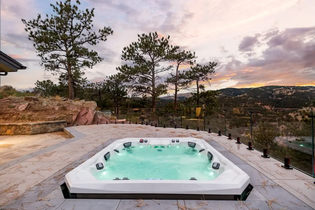 155 Wildwood Lane Home in Boulder, Colorado. Discover tranquility and luxury in this Pine Brook Hills home featuring stunning views of the Continental Divide. With an open floorplan, contemporary finishes, and spacious outdoor decks, this Boulder retreat offers a perfect blend of modern living and natural beauty.