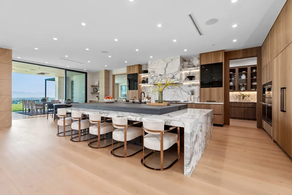25079 Jim Bridger Road Home in Calabasas, California. Discover the epitome of refined luxury in this stunning new estate on a beautiful 1.6-acre lot in Hidden Hills. The open floor plan features a chef's kitchen, butler's pantry, and expansive great room with sliding walls of glass. Enjoy amenities like a home theater, large game room, and an oversized gym & spa.