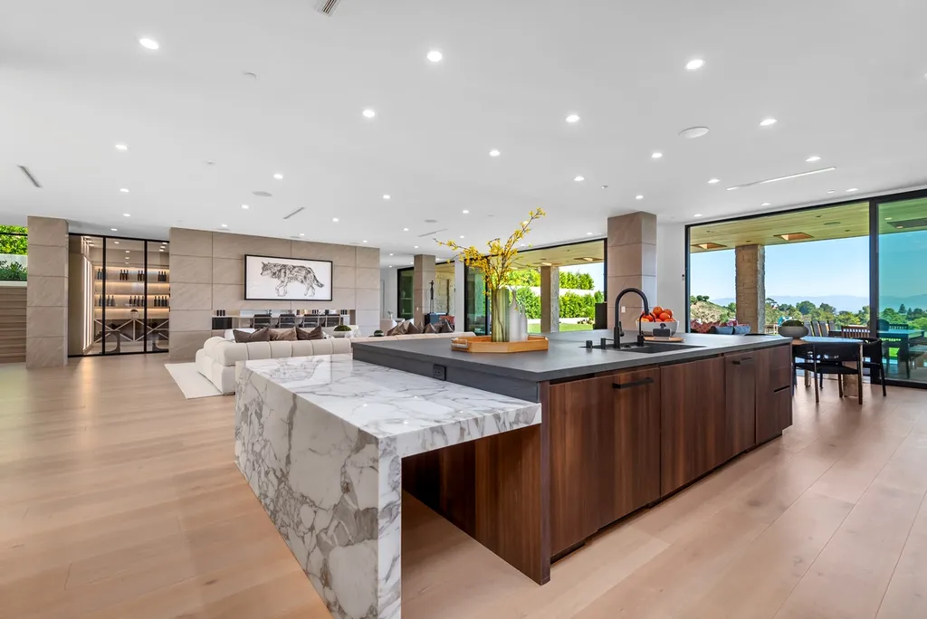 25079 Jim Bridger Road Home in Calabasas, California. Discover the epitome of refined luxury in this stunning new estate on a beautiful 1.6-acre lot in Hidden Hills. The open floor plan features a chef's kitchen, butler's pantry, and expansive great room with sliding walls of glass. Enjoy amenities like a home theater, large game room, and an oversized gym & spa.
