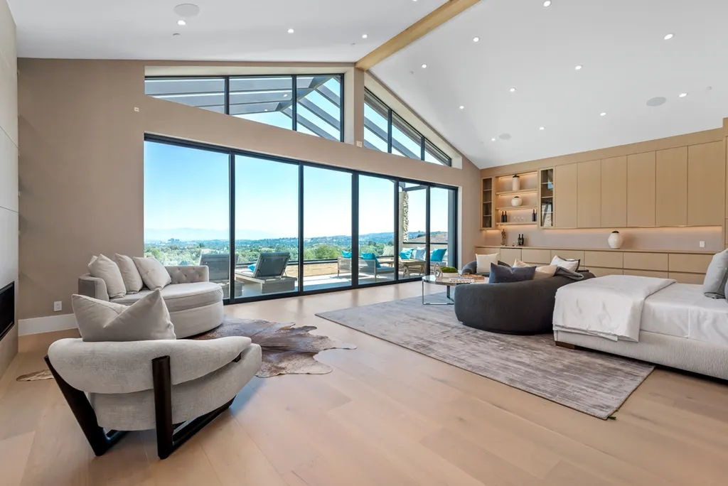 25079 Jim Bridger Road Home in Calabasas, California. Discover the epitome of refined luxury in this stunning new estate on a beautiful 1.6-acre lot in Hidden Hills. The open floor plan features a chef's kitchen, butler's pantry, and expansive great room with sliding walls of glass. Enjoy amenities like a home theater, large game room, and an oversized gym & spa.