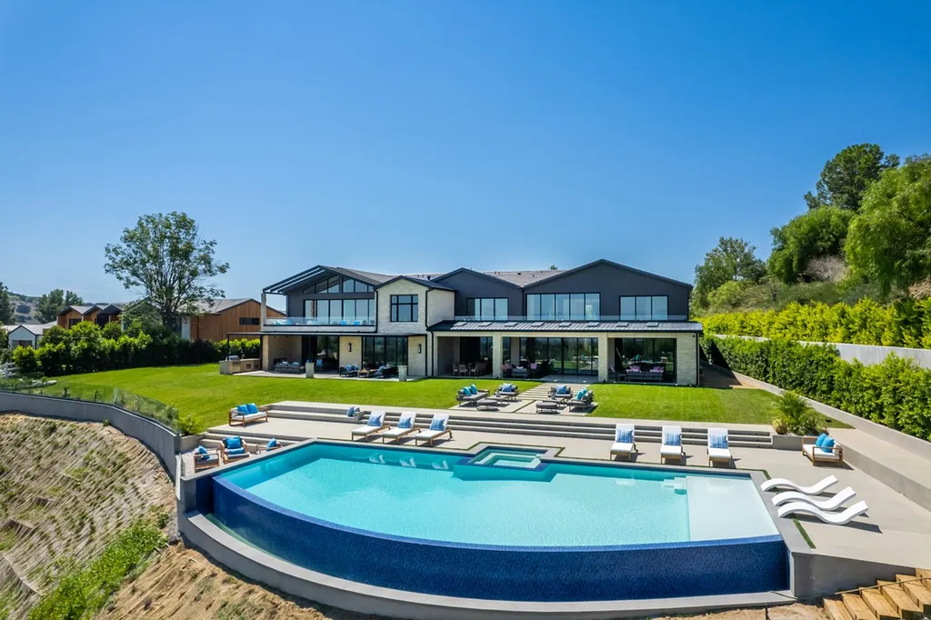 25079 Jim Bridger Road Home in Calabasas, California. Discover the epitome of refined luxury in this stunning new estate on a beautiful 1.6-acre lot in Hidden Hills. The open floor plan features a chef's kitchen, butler's pantry, and expansive great room with sliding walls of glass. Enjoy amenities like a home theater, large game room, and an oversized gym & spa.