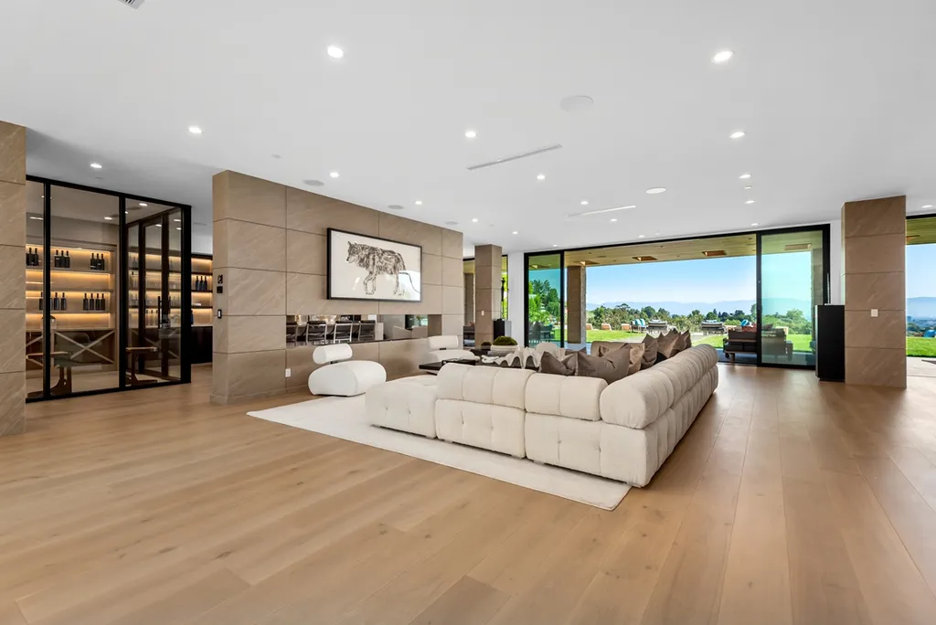 25079 Jim Bridger Road Home in Calabasas, California. Discover the epitome of refined luxury in this stunning new estate on a beautiful 1.6-acre lot in Hidden Hills. The open floor plan features a chef's kitchen, butler's pantry, and expansive great room with sliding walls of glass. Enjoy amenities like a home theater, large game room, and an oversized gym & spa.
