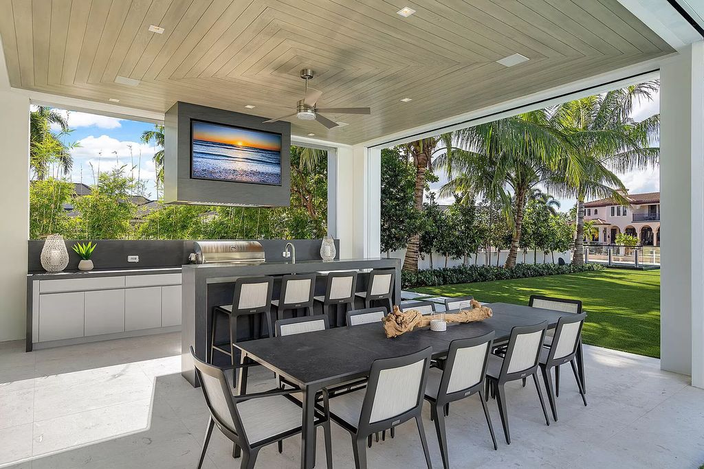 Indulge in the epitome of waterfront luxury at this 10,784-square-foot estate in Royal Palm Yacht & Country Club. Crafted by Wietsma Lippolis Construction, this masterpiece boasts six bedroom suites, expansive living areas curated by Artisan Interiors, and cutting-edge Crestron home technology.
