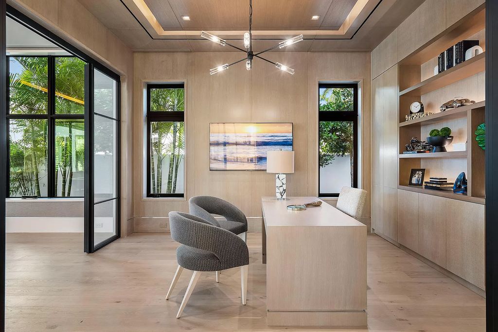 Indulge in the epitome of waterfront luxury at this 10,784-square-foot estate in Royal Palm Yacht & Country Club. Crafted by Wietsma Lippolis Construction, this masterpiece boasts six bedroom suites, expansive living areas curated by Artisan Interiors, and cutting-edge Crestron home technology.