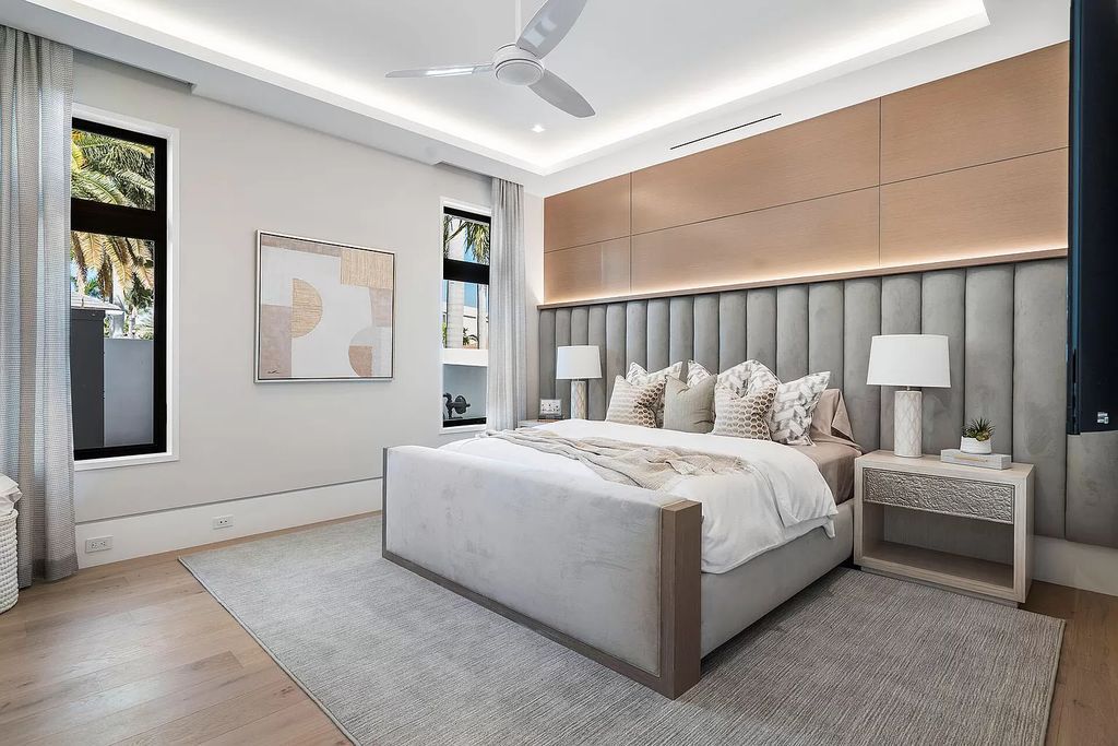 Indulge in the epitome of waterfront luxury at this 10,784-square-foot estate in Royal Palm Yacht & Country Club. Crafted by Wietsma Lippolis Construction, this masterpiece boasts six bedroom suites, expansive living areas curated by Artisan Interiors, and cutting-edge Crestron home technology.