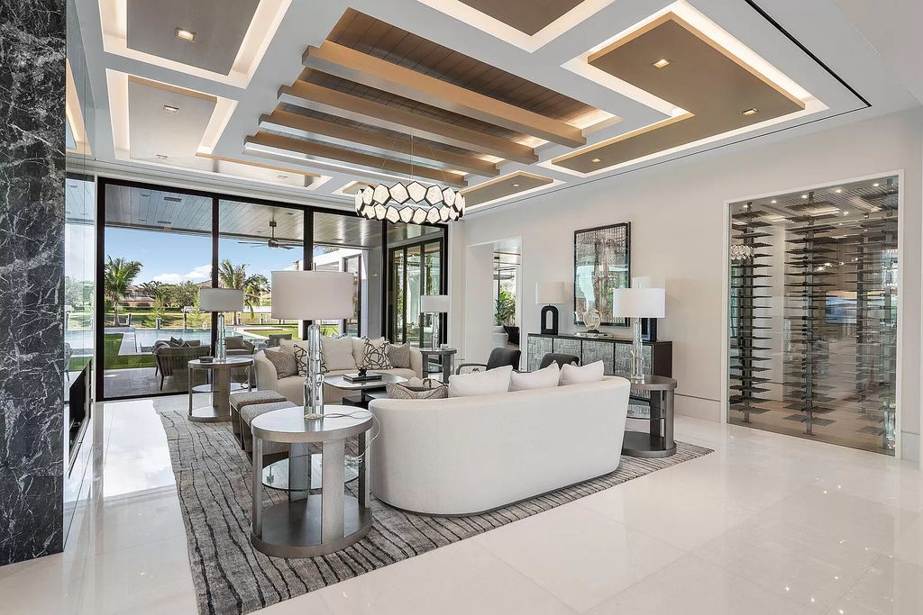 Indulge in the epitome of waterfront luxury at this 10,784-square-foot estate in Royal Palm Yacht & Country Club. Crafted by Wietsma Lippolis Construction, this masterpiece boasts six bedroom suites, expansive living areas curated by Artisan Interiors, and cutting-edge Crestron home technology.