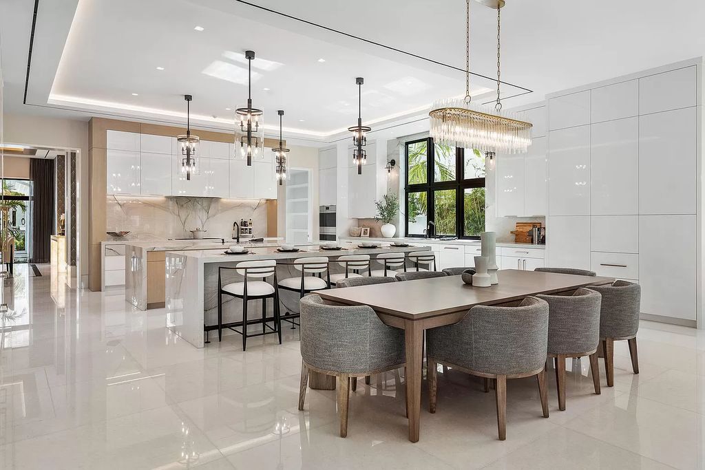 Indulge in the epitome of waterfront luxury at this 10,784-square-foot estate in Royal Palm Yacht & Country Club. Crafted by Wietsma Lippolis Construction, this masterpiece boasts six bedroom suites, expansive living areas curated by Artisan Interiors, and cutting-edge Crestron home technology.