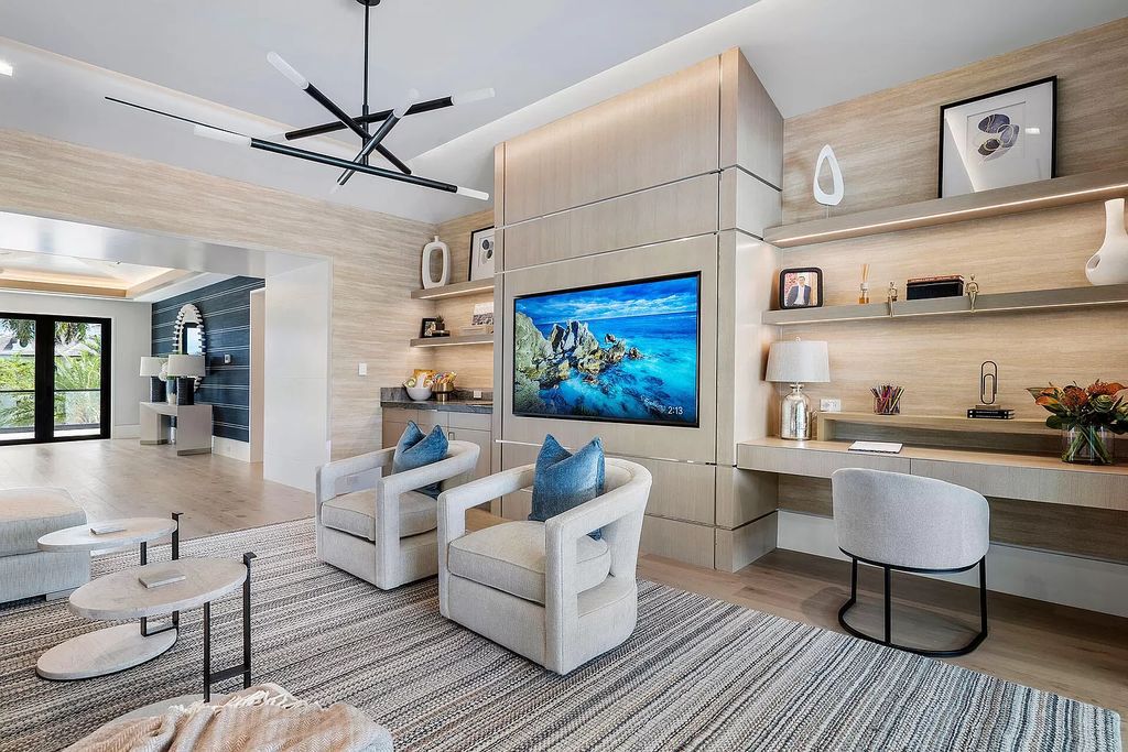 Indulge in the epitome of waterfront luxury at this 10,784-square-foot estate in Royal Palm Yacht & Country Club. Crafted by Wietsma Lippolis Construction, this masterpiece boasts six bedroom suites, expansive living areas curated by Artisan Interiors, and cutting-edge Crestron home technology.