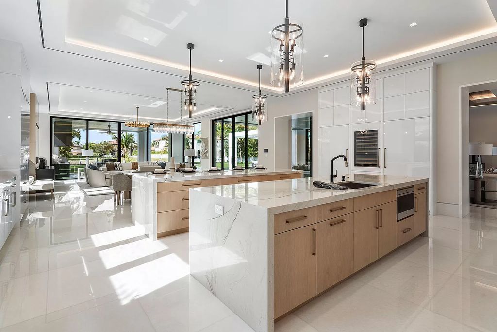 Indulge in the epitome of waterfront luxury at this 10,784-square-foot estate in Royal Palm Yacht & Country Club. Crafted by Wietsma Lippolis Construction, this masterpiece boasts six bedroom suites, expansive living areas curated by Artisan Interiors, and cutting-edge Crestron home technology.